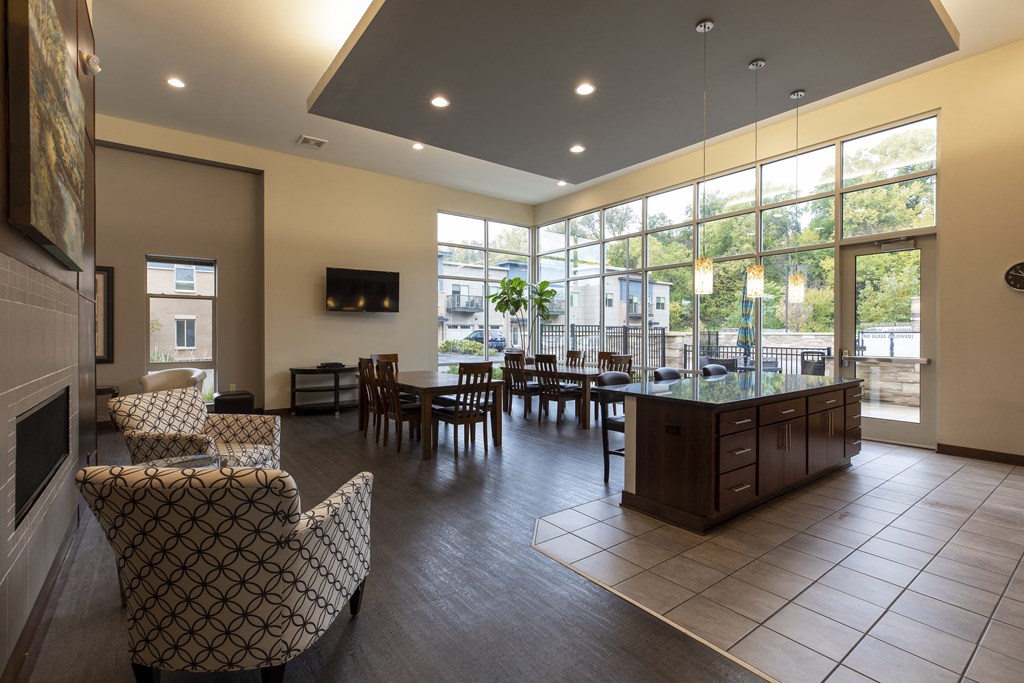 a large living room with a table and chairs and a fireplace