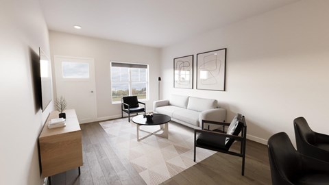 A living room with a grey sofa, a black chair and a wooden side table.