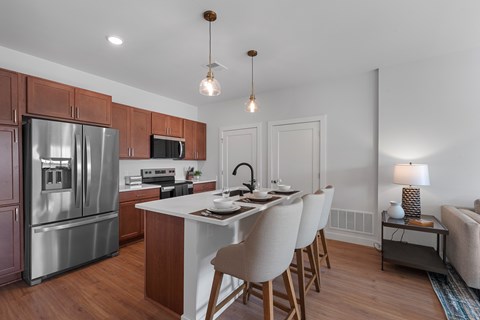 A modern kitchen with a dining table and chairs.