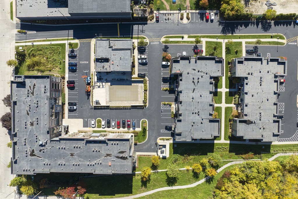 an aerial view of a parking lot with cars on it