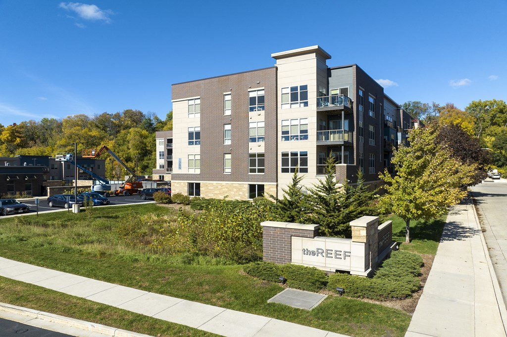 an apartment building with a construction site and a sign in front