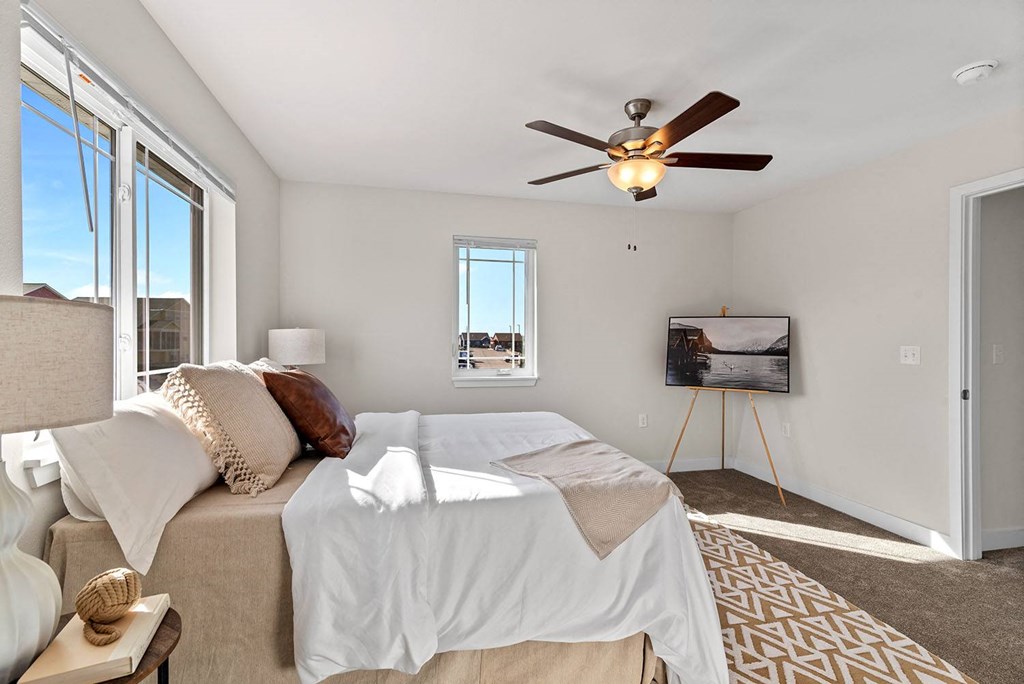 a bedroom with a bed and a ceiling fan at The Residences Apartments at Bear Tree, WI, DeForest, 53532