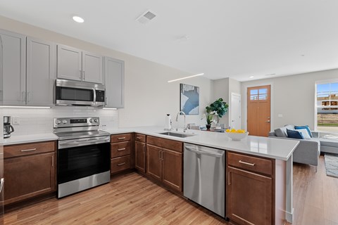 A modern kitchen with wooden cabinets and stainless steel appliances.