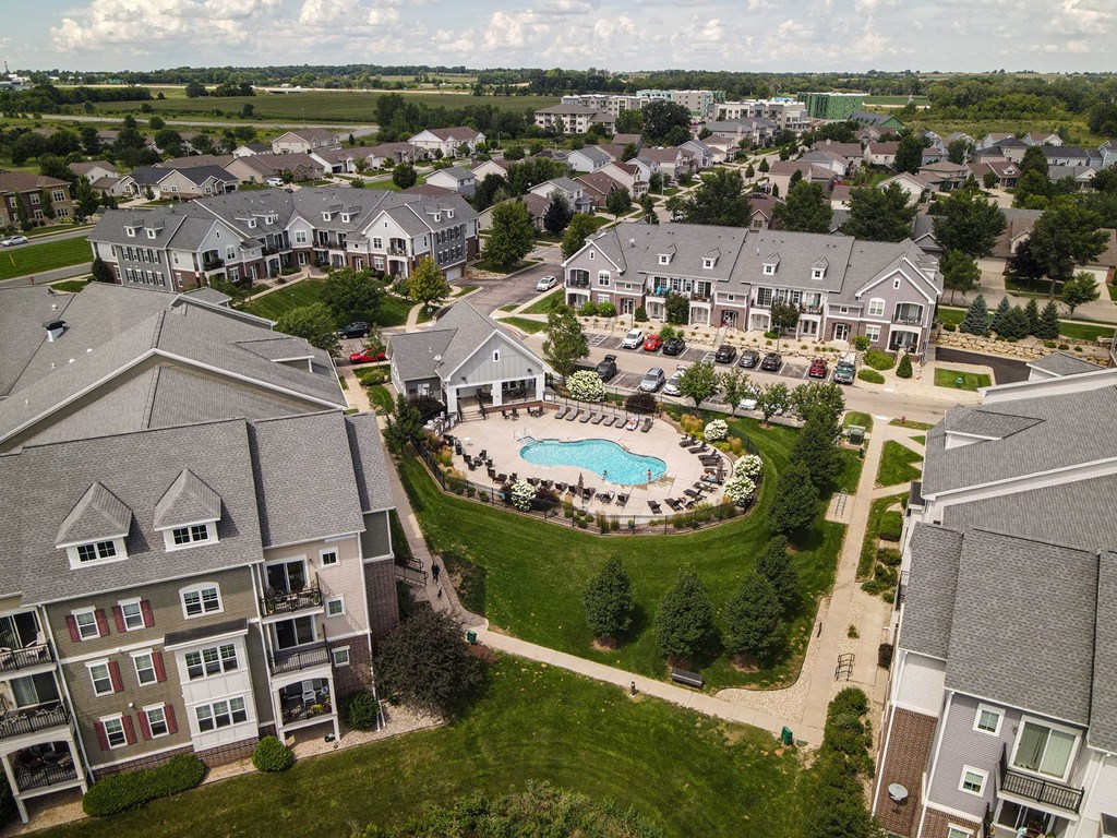an aerial view of an apartment complex with a swimming pool