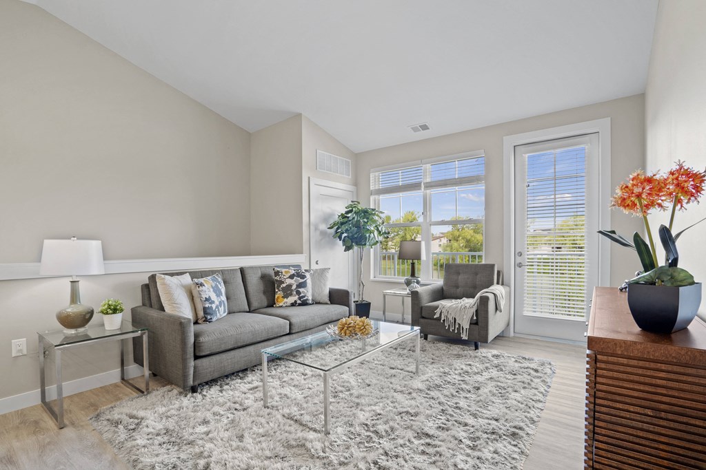a living room with a couch and a glass coffee table