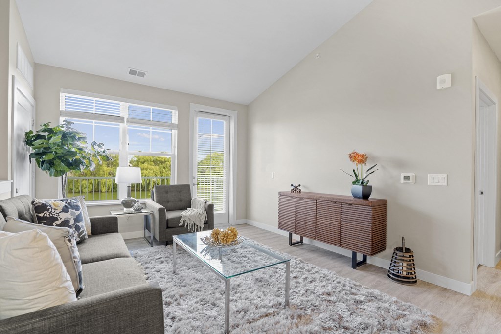 a living room with a couch and a glass coffee table