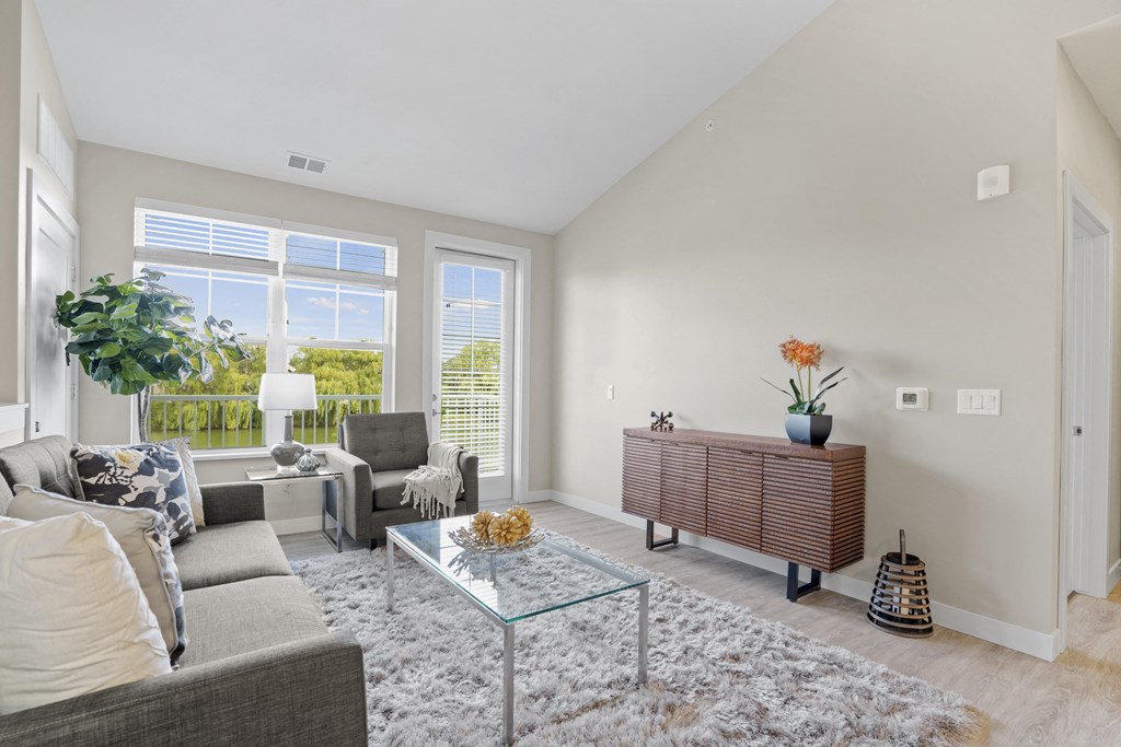 a living room with a couch and a glass coffee table