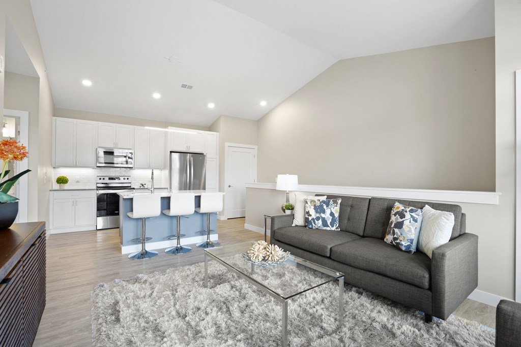 a living room with a couch and a glass coffee table