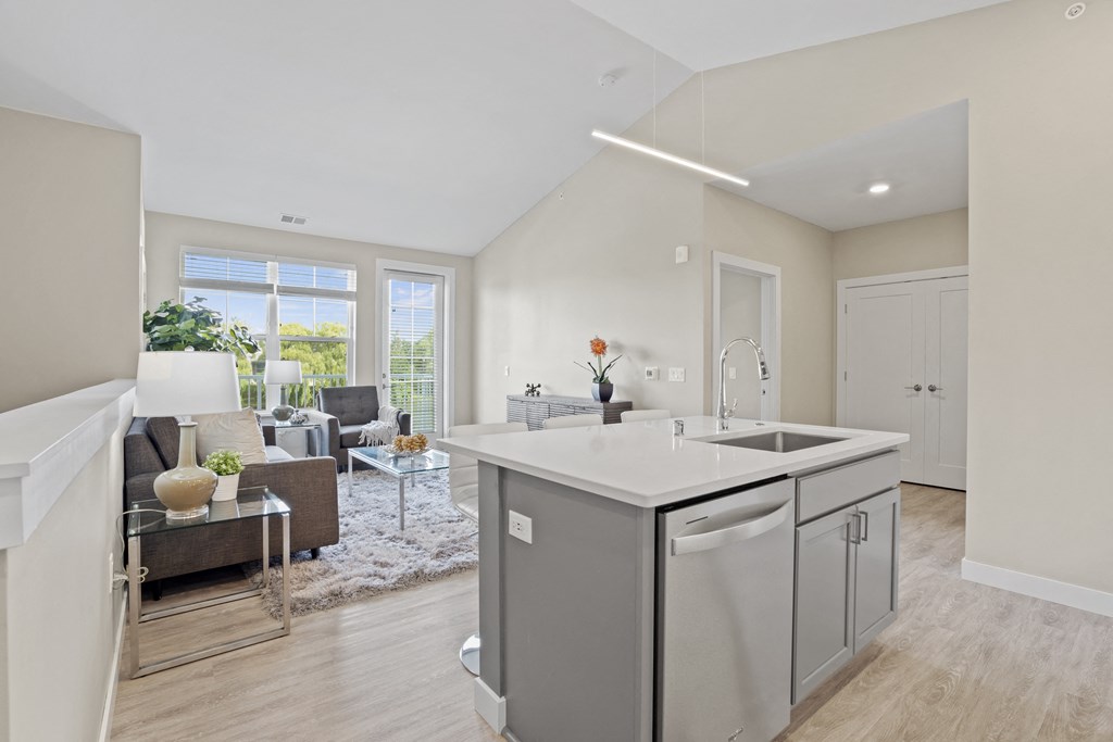 an open kitchen and living room with a large window