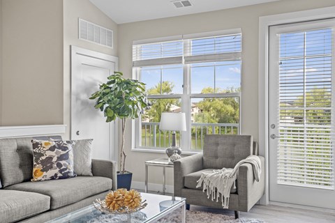 a living room with a couch and a coffee table and a window