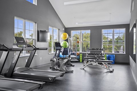 the gym with treadmills and weights at the belgard apartments