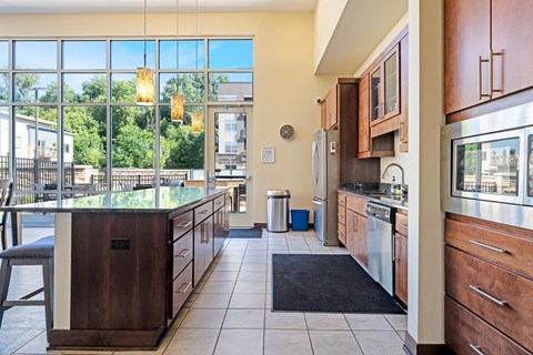 A kitchen with a large window and a view of the city.
