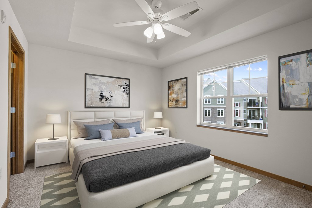 a bedroom with a bed and a ceiling fan