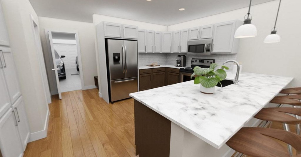 a kitchen with a marble counter top and a stainless steel refrigerator  at Tivoli Green Apartments & Townhomes, Mount Pleasant, 53406