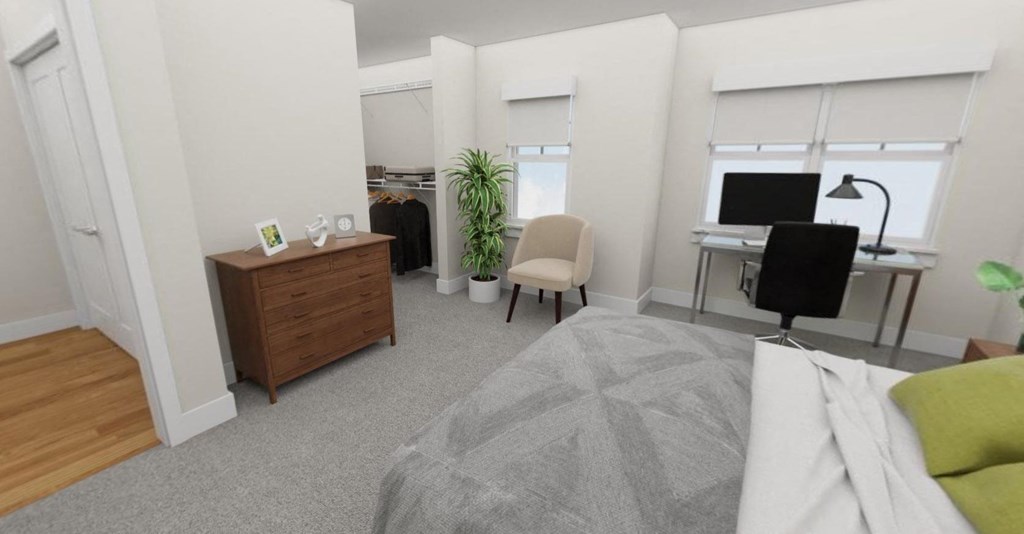 a bedroom with a bed and a desk with a computer  at Tivoli Green Apartments & Townhomes, Wisconsin, 53406