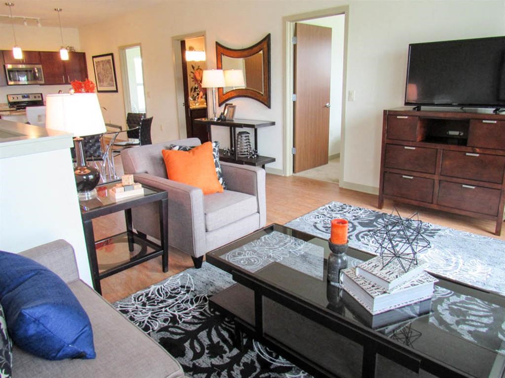 a living room with a couch and a table and a television