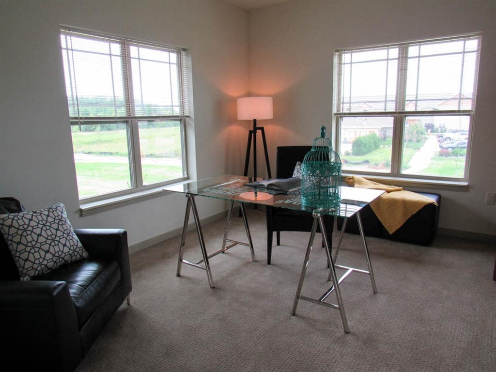 a living room with a glass desk and a couch