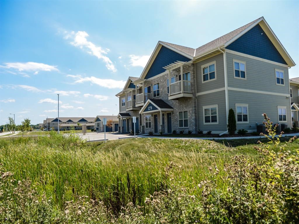 a row of houses with grass in front of them