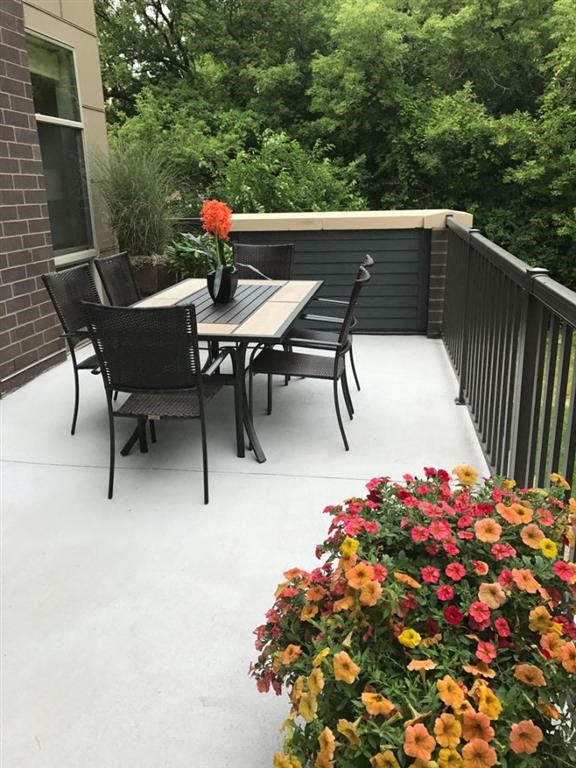 a patio with a table and chairs on a