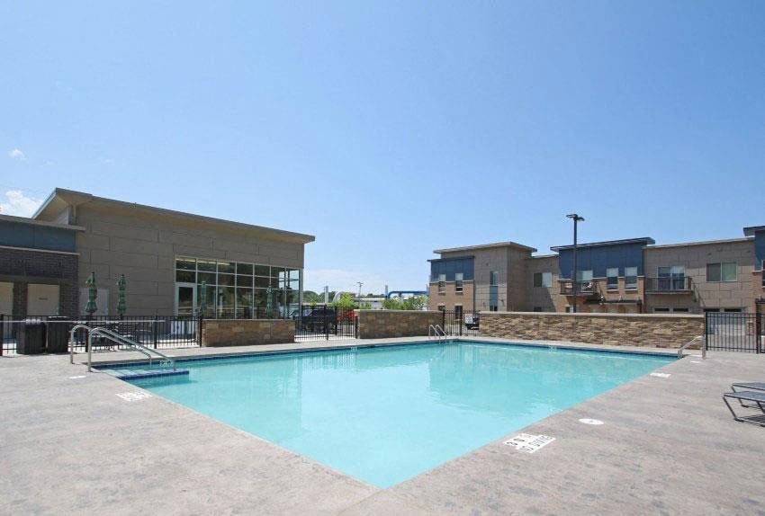 a swimming pool with a building in the background