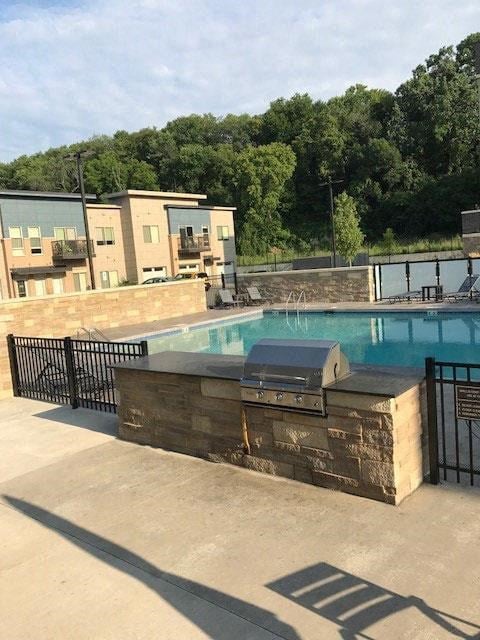 a swimming pool with a table and a fence