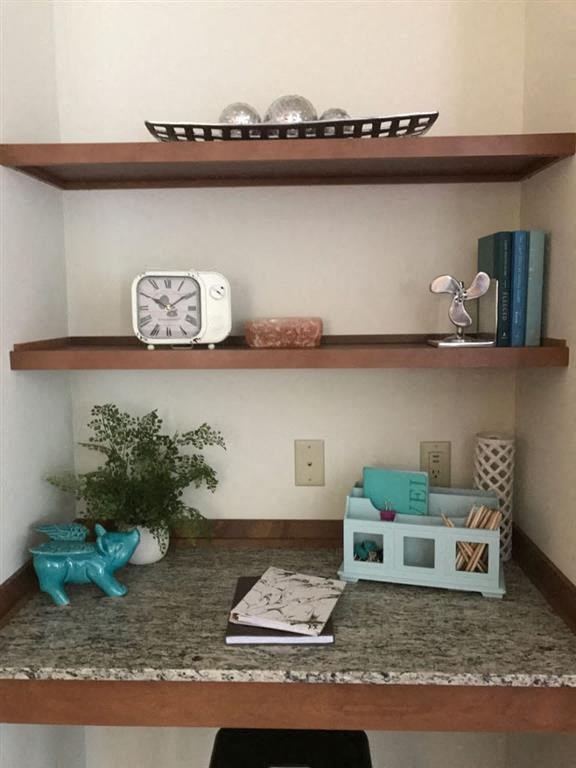 a shelf with a clock and other items on it