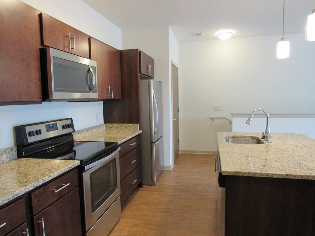 a kitchen with granite counter tops and stainless steel appliances