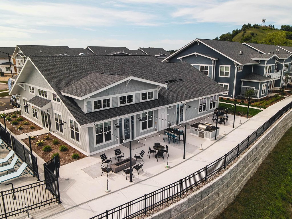 an aerial view of a house with tables and chairs in front of it