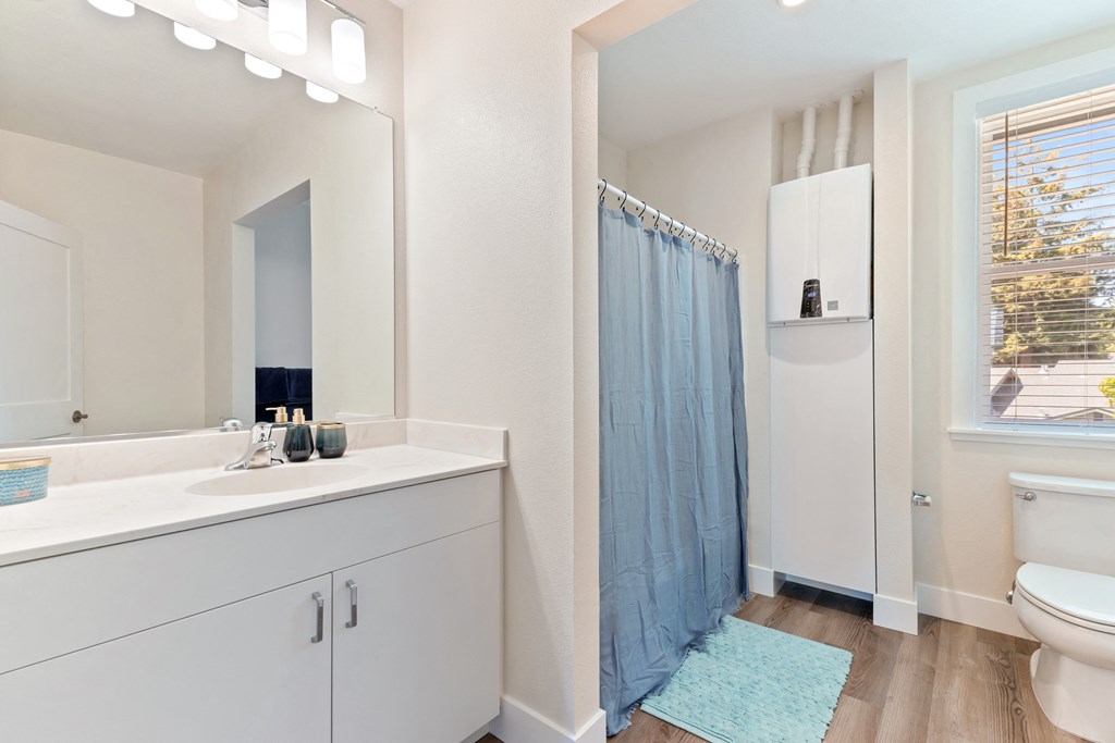 bathroom view with shower, sink, and toilet