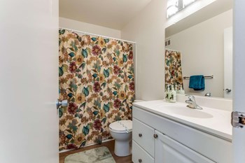 bathroom with shower curtain, toilet and sink - Photo Gallery 15
