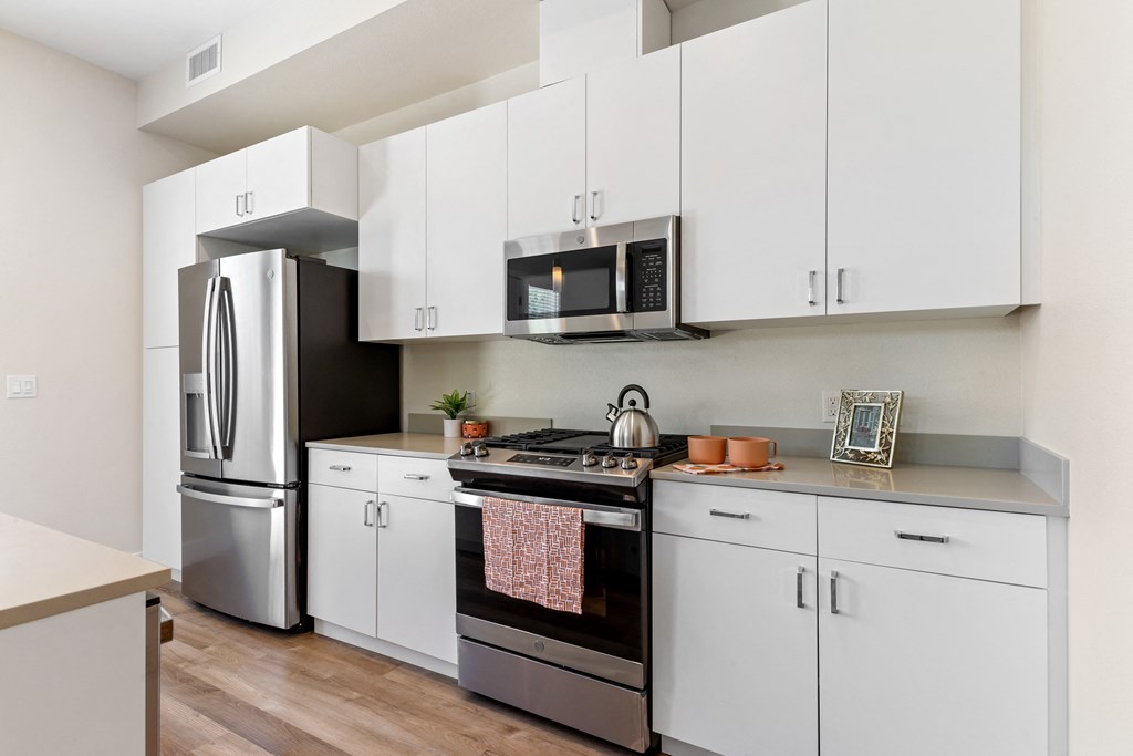 kitchen view with fridge, stove, and microwave