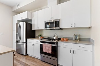 kitchen view with fridge, stove, and microwave