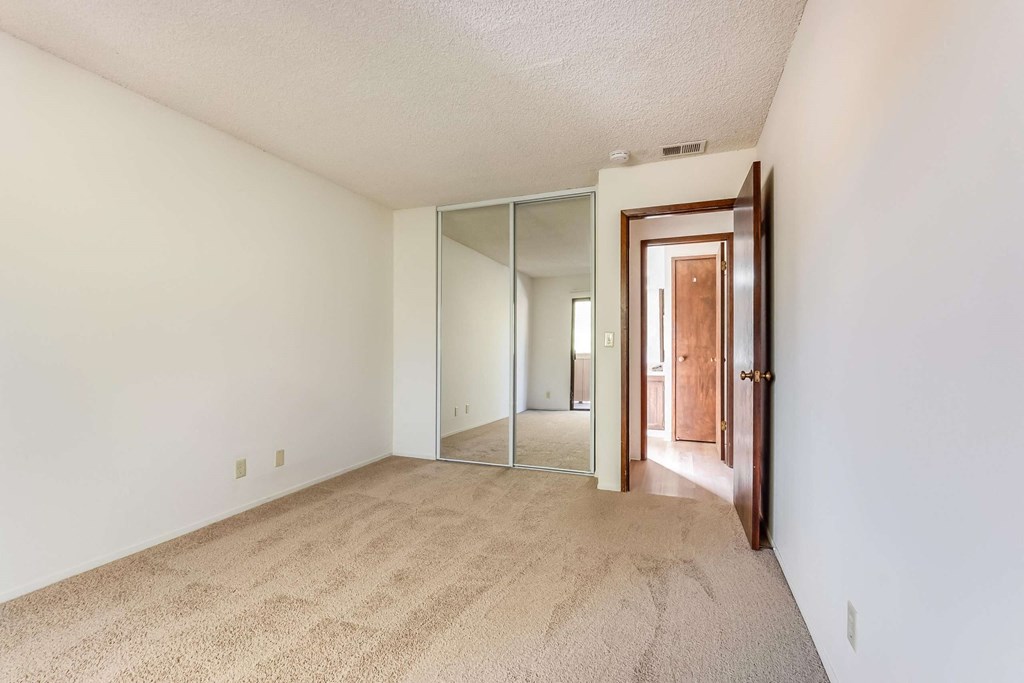bedroom with mirrored closet doors