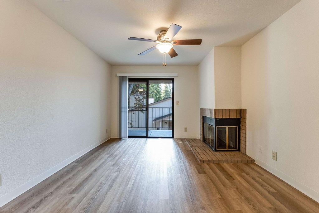 living room with fireplace and ceiling fan