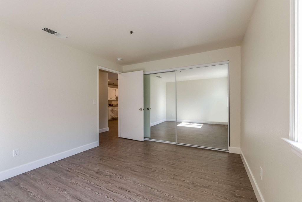 bedroom with mirrored closet doors
