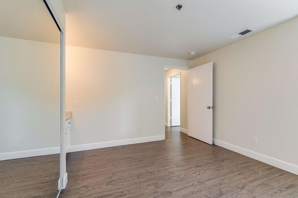 Bedroom with mirrored closet doors