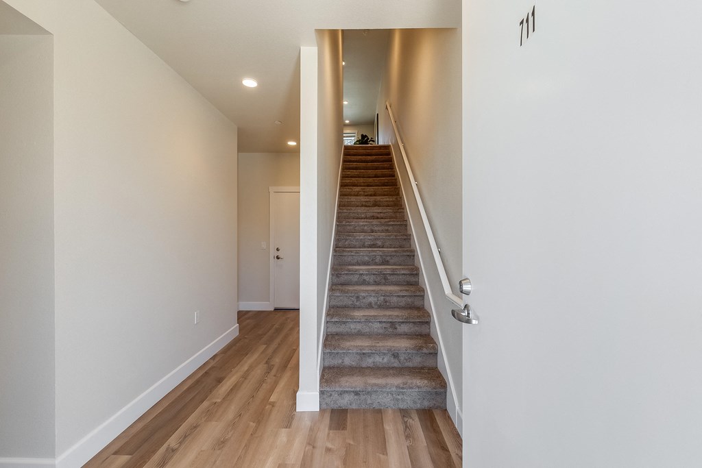 2 bedroom entry view of stairs to upper floor