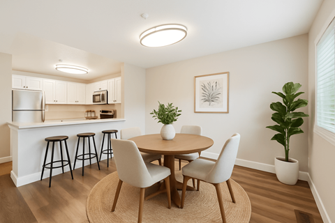 A kitchen with a bar and a dining table with chairs.