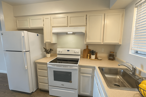 A kitchen with a white refrigerator and a white oven.at Posada East, Novato, CA 94949