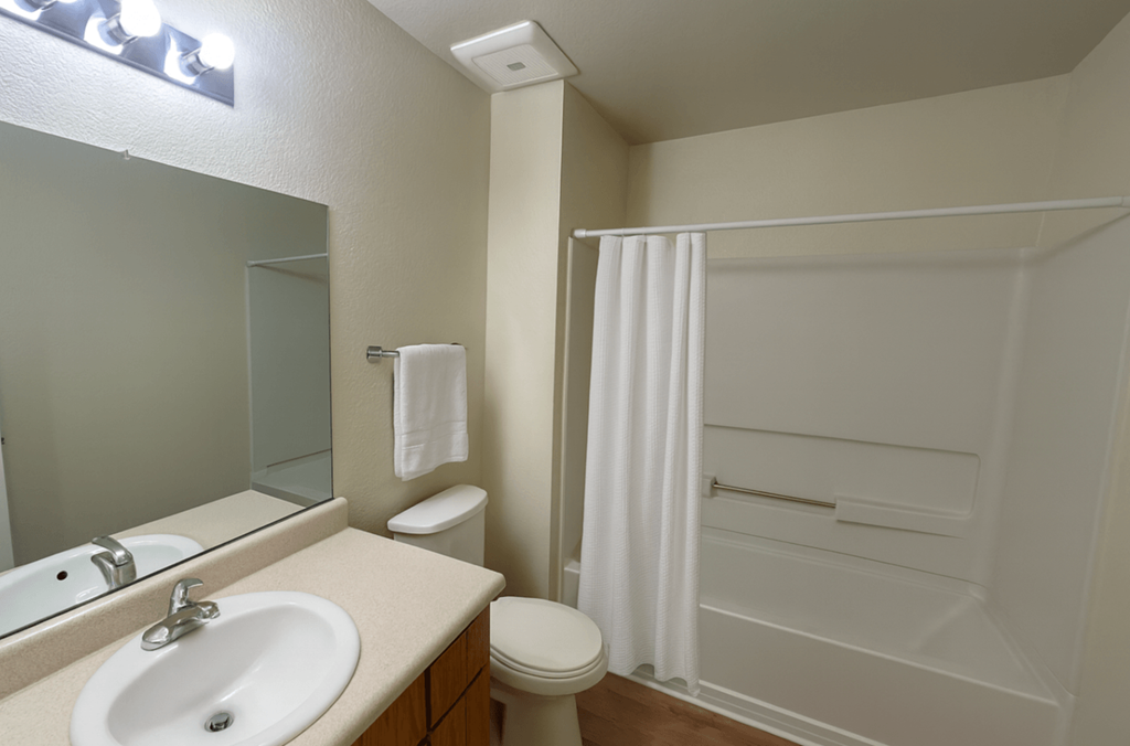 A white bathroom with a sink, toilet, and bathtub.at Vintage Pointe, Rohnert Park