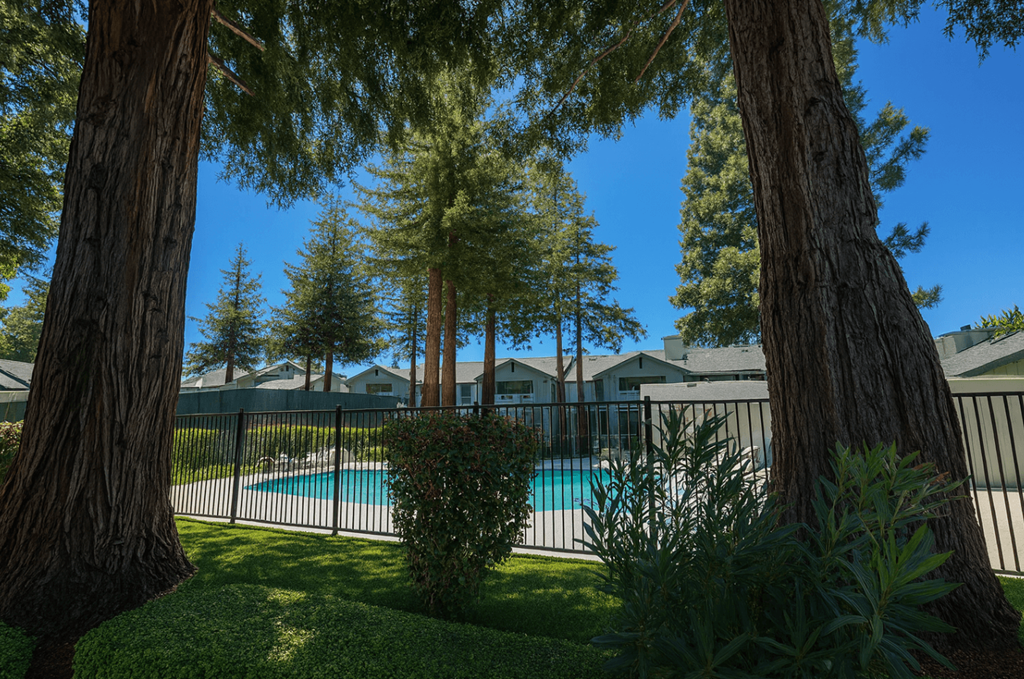 A pool surrounded by trees and a fence.at Vintage Pointe, Rohnert Park