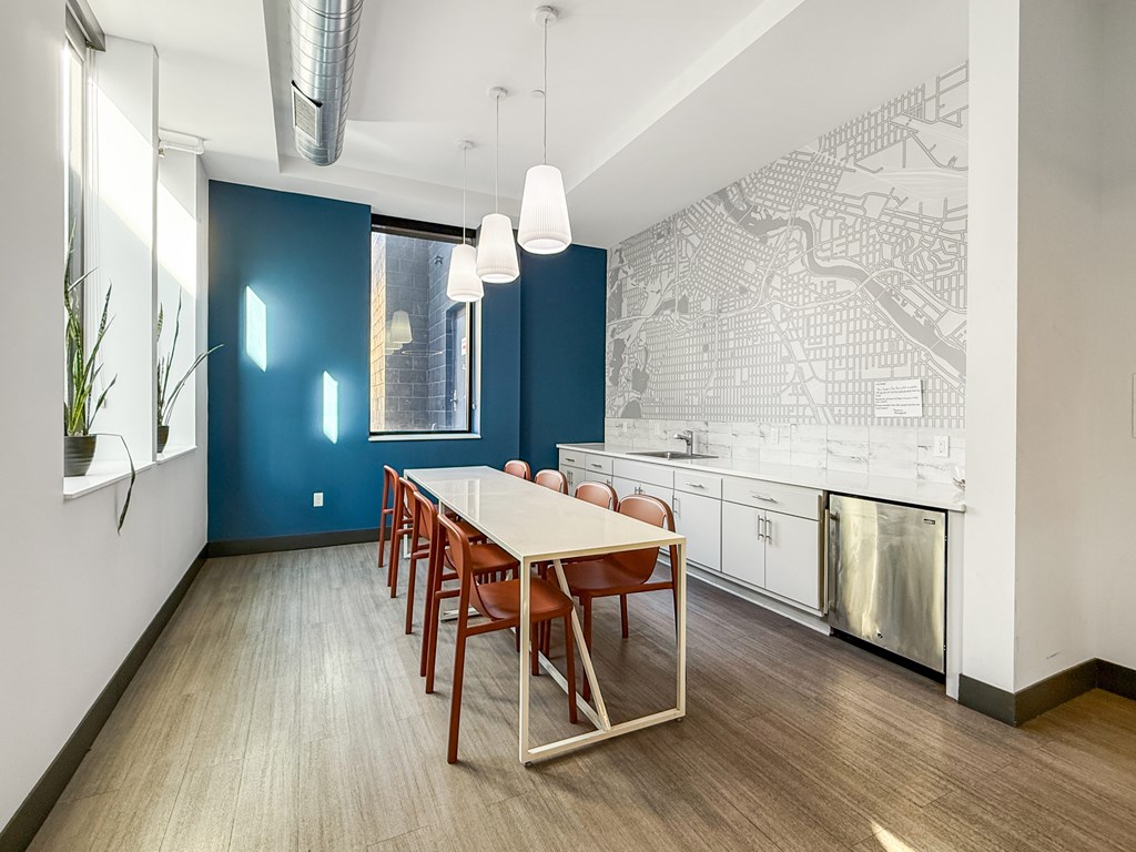 A dining room with a long table and chairs.