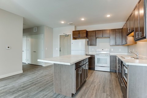 A modern kitchen with wooden cabinets and stainless steel appliances.