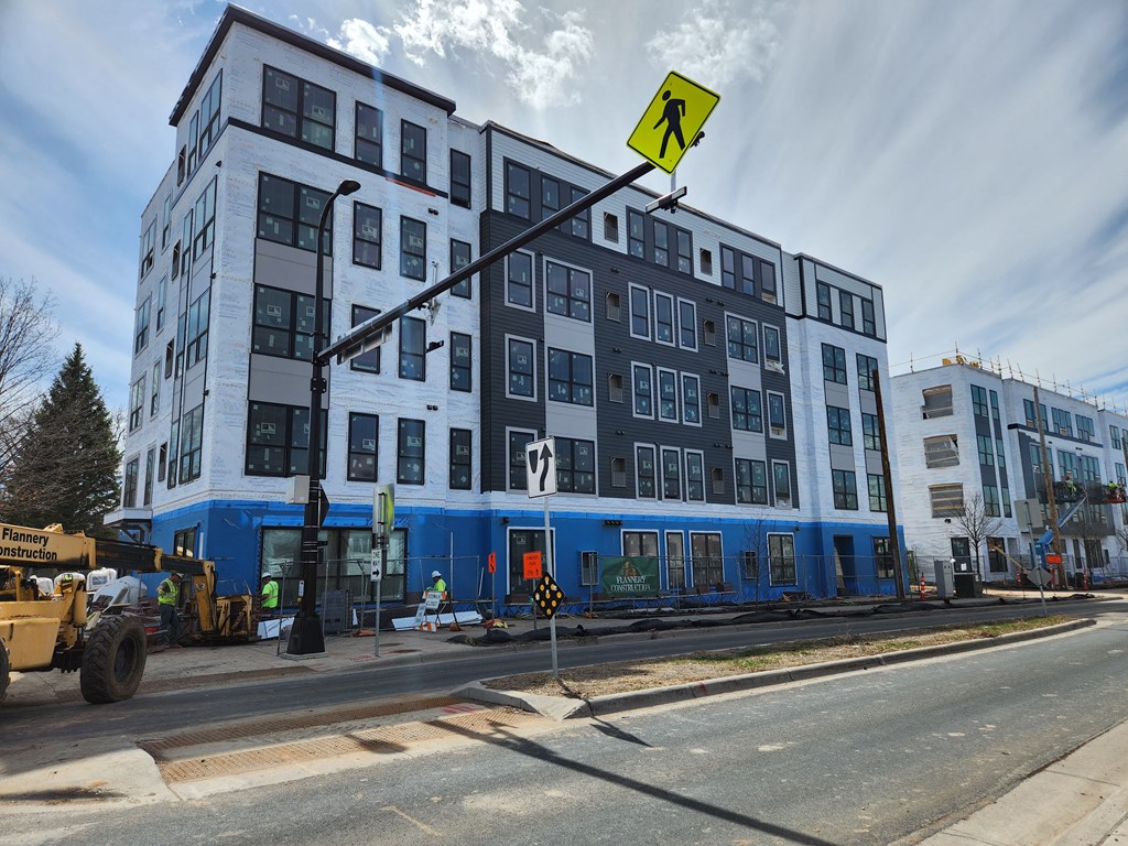 a new building being constructed on the corner of a city street