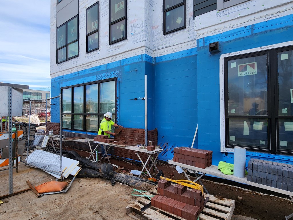 a construction worker working on the side of a building