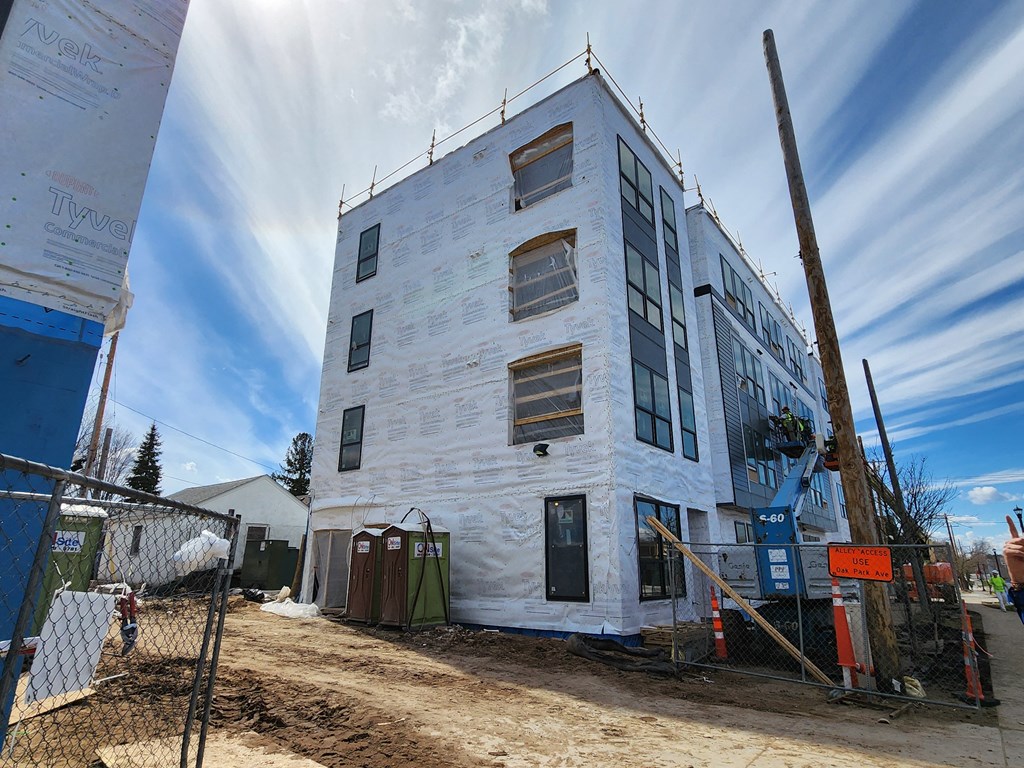 a white building under construction with a fence