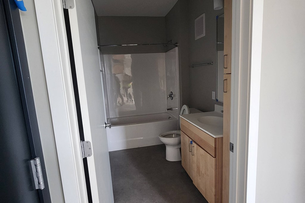 a small bathroom with a sink toilet and bath tub