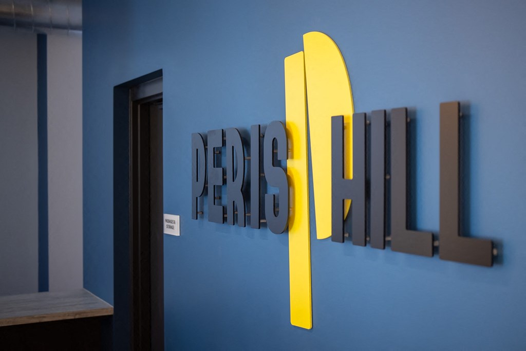 a blue wall with a sign that says design refresh on it