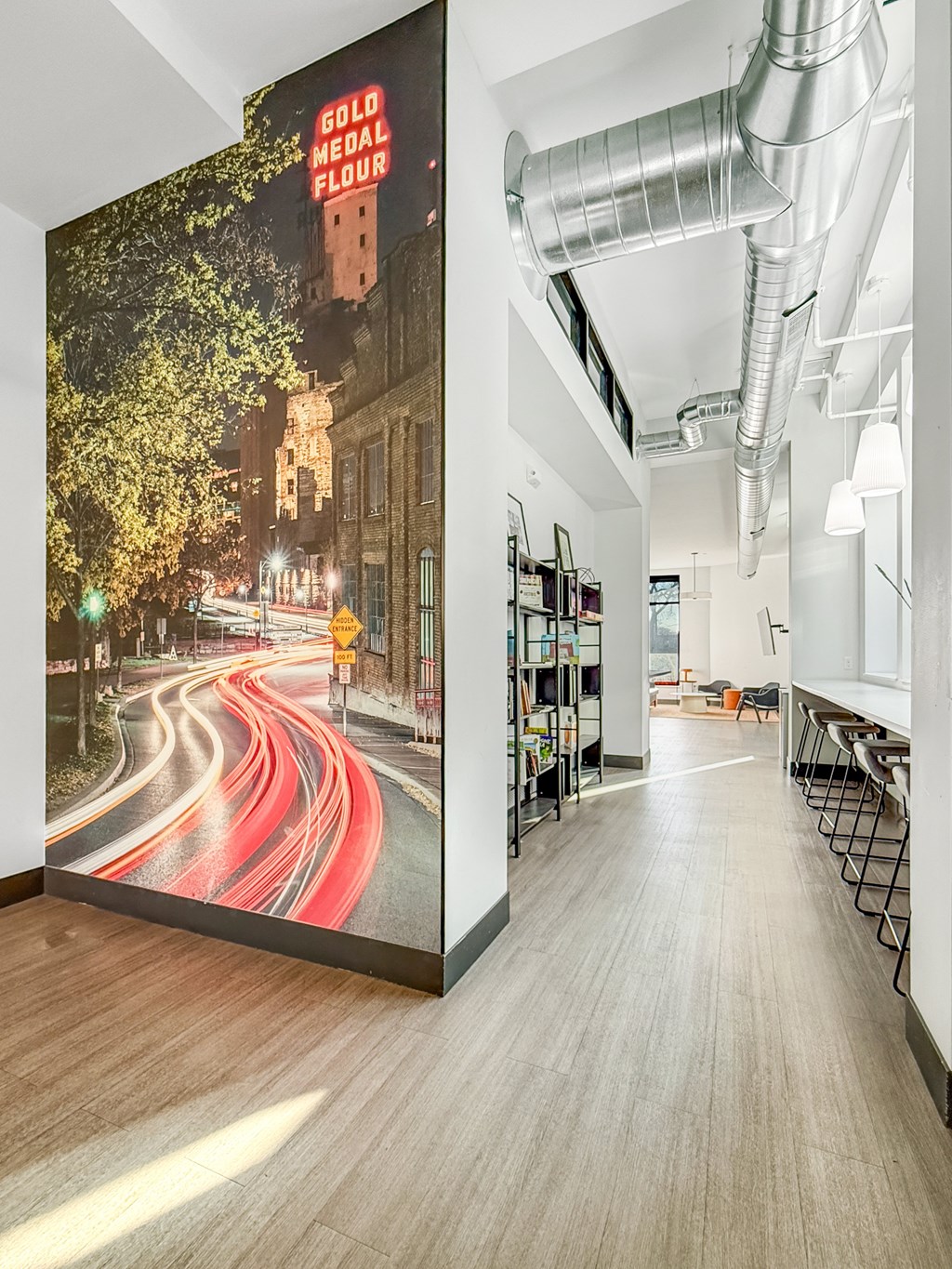 A long hallway with a mural of a city street on the wall.