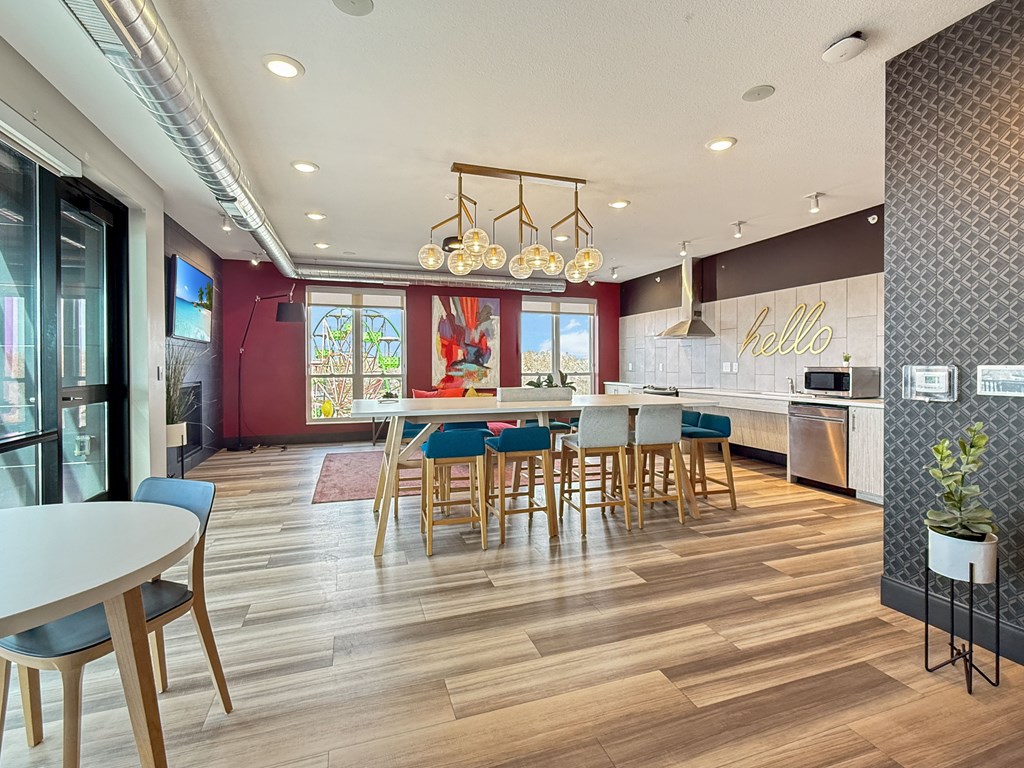 A modern kitchen with a dining table and chairs.